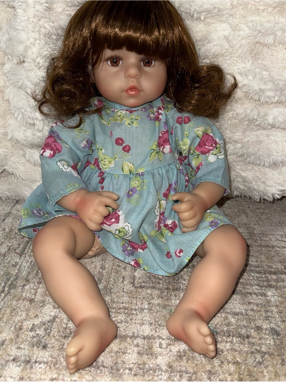 Realistic brunette baby girl in dress